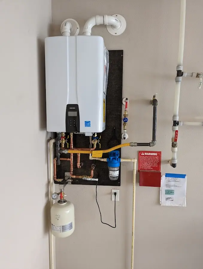 Professional plumber installing copper piping in a Winchester home